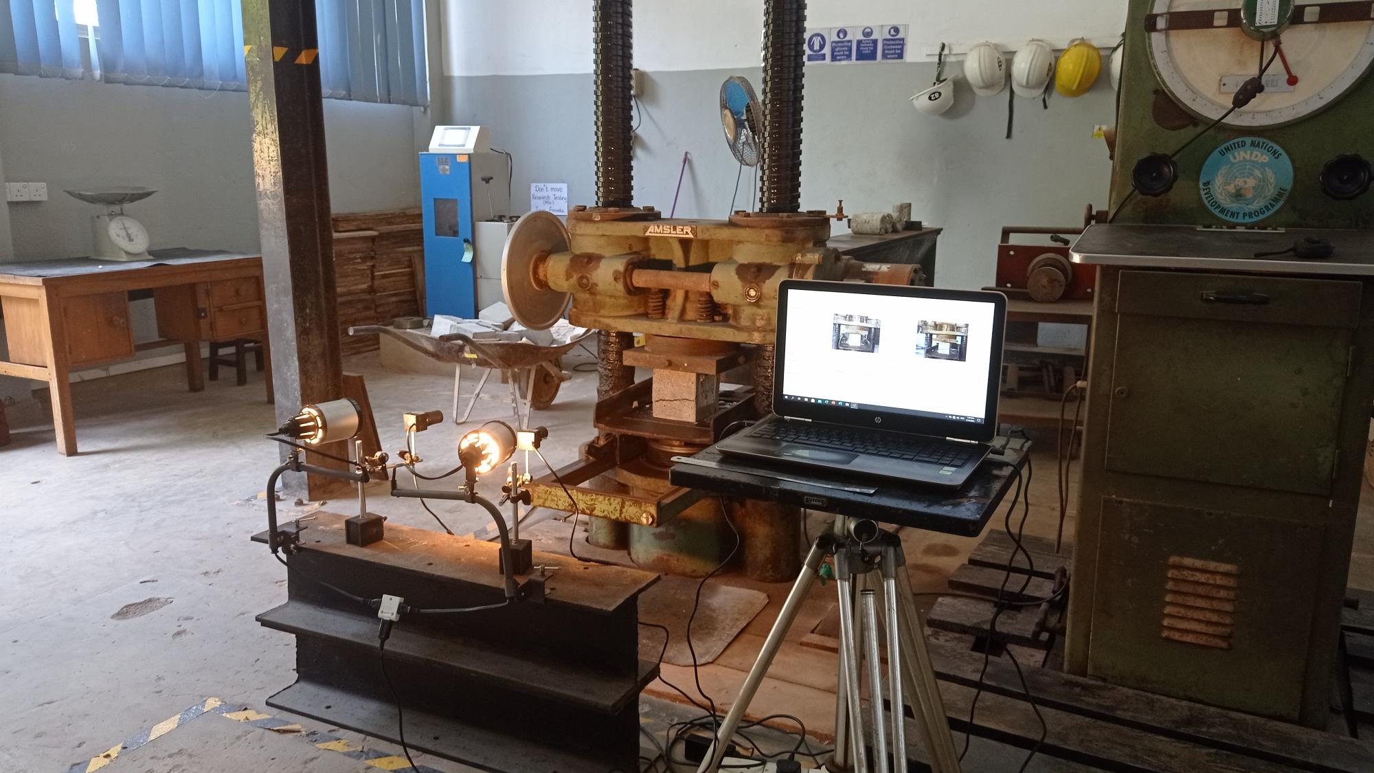 Specimen positioned under the loading frame for DIC testing